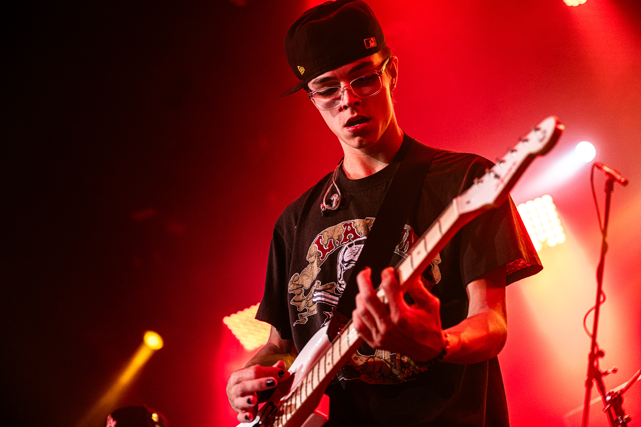 After9 guitarist performing under red lights