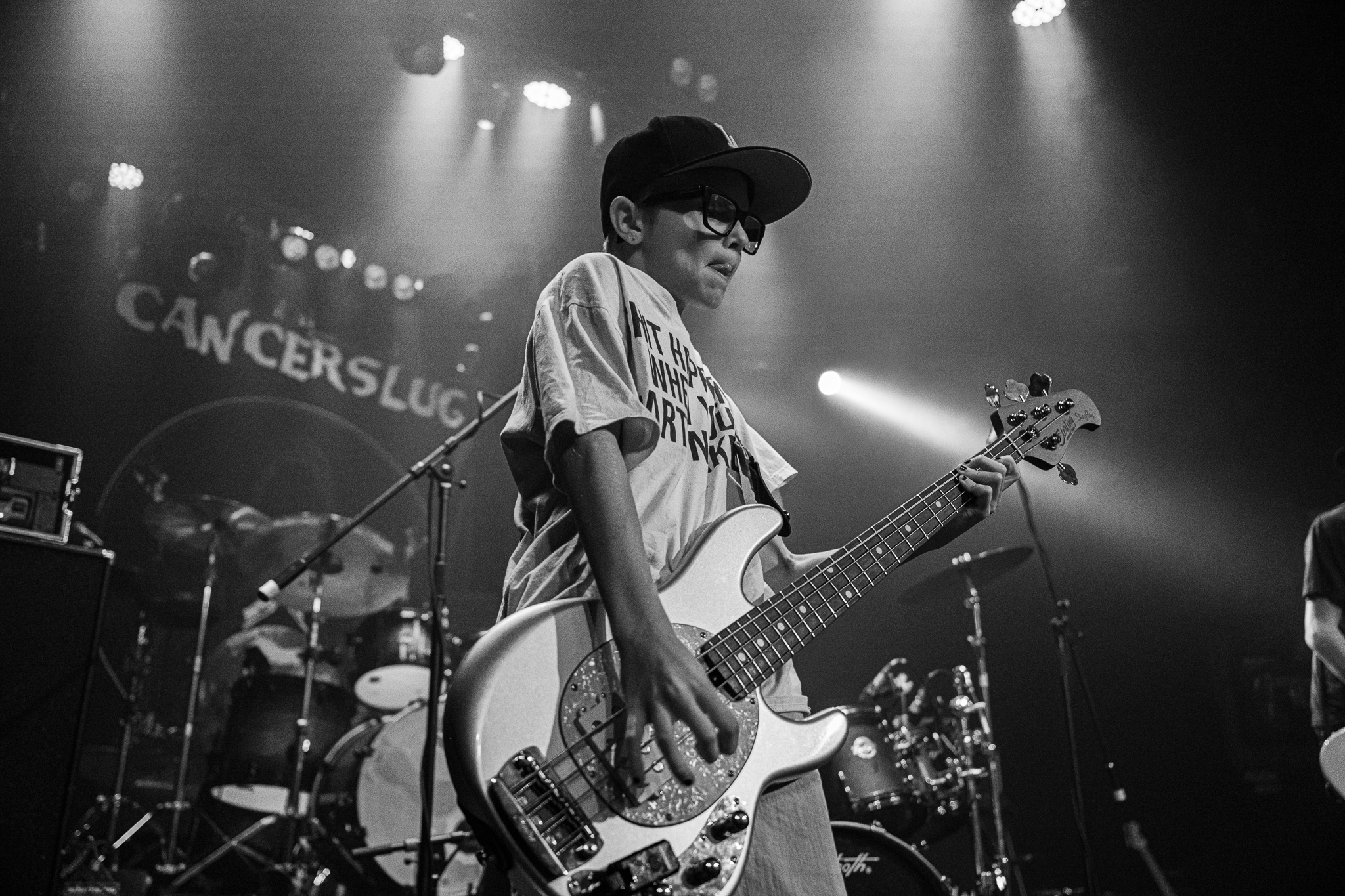 After9 bassist performing in black and white